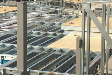 Internal view of x-braced cross walls beneath profiled steel decking.