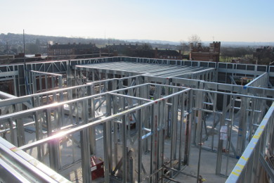 Light steel framing wall panels delivered just-in-time and built on composite concrete slab.