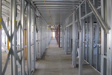 Internal view of x-braced cross walls beneath profiled steel decking.
