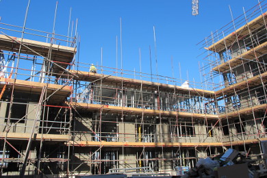 Light steel frame elevation showing scaffolding and cement particle board sheathing.